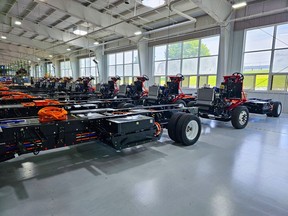 The picture depicts several Xos chassis that are lined up to prepare for steps to be delivered to customers.