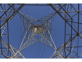 Power lines hang from a transmission tower on Torrens Island, South Australia, on Monday, April 2, 2018. A plan by Tesla Inc. to build the world's largest virtual power plant may be in jeopardy after the South Australian political party that championed the deal was ousted from government, setting up a potential retreat from ambitious renewable energy targets. Photographer: Carla Gottgens/Bloomberg