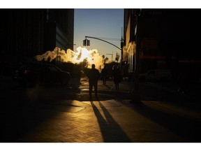 Steam rises as pedestrians cross a street near the New York Stock Exchange (NYSE) in New York, U.S., on Thursday, Dec. 27, 2018. Volatility returned to U.S. markets, with stocks tumbling back toward a bear market after the biggest rally in nearly a decade evaporates. Photographer: John Taggart/Bloomberg