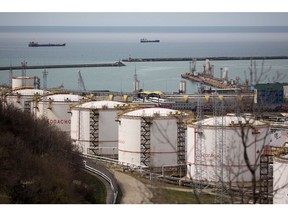 Oil storage tanks stand at the RN-Tuapsinsky refinery, operated by Rosneft Oil Co., as tankers sail beyond in Tuapse, Russia, on Monday, March 23, 2020. Major oil currencies have fallen much more this month following the plunge in Brent crude prices to less than $30 a barrel, with Russia's ruble down by 15%. Photographer: Andrey Rudakov/Bloomberg