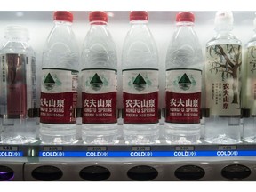 Bottles of Nongfu Spring Co. water at a vending machine in Shanghai, China, on Wednesday, Jan. 6, 2021. The chairman of Nongfu, a bottled-water company that's ubiquitous in China, is now richer than Warren Buffett as his fortune surged $13.5 billion since the start of the year to $91.7 billion on Tuesday, according to the Bloomberg Billionaires Index.