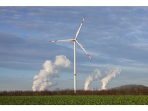 A wind turbine near a coal-fired power plant in Bergheim, Germany.