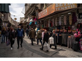 Shoppers pass a clothing store in Istanbul.