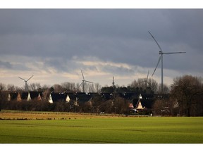 Wind turbines beyond housing near Wusterhusen, Germany, on Saturday Jan. 14, 2023. Chancellor Olaf Scholz said Germany needs to increase its pace of expanding renewable power to reach its goal of becoming climate-neutral by 2045, even as Europe's largest economy withstands the initial impact of Russia's energy squeeze.