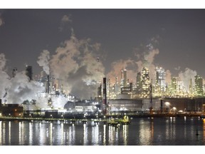 Smoke billows from the illuminated GS Caltex Corp. oil refinery facility at dawn in the Yeosu Industrial Complex in Yeosu, South Korea, on Tuesday, Feb. 7, 2023. South Korea is schedule to release its trade figures on Feb. 15.