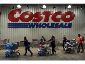 Shoppers outside a Costco store in New York. Photographer: Bing Guan/Bloomberg