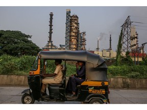 An autorickshaw drives past an oil refinery operated by Hindustan Petroleum Corp., in Mumbai, India, on Tuesday, Oct. 3, 2023. Oil prices need to fall to levels of around $80 a barrel to be good for consumers, India's Oil Minister Hardeep Puri said, adding that the third largest consumer in the world will continue to buy where it finds the best prices. Photographer: Dhiraj Singh/Bloomberg