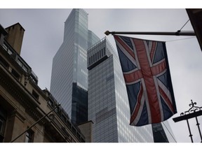 A British Union flag near commercial office buildings in the City of London, UK, on Wednesday, Oct. 25, 2023. British workers coming into the office every day outnumber those who spend part of the week working from home, for the first time since the end of pandemic restrictions. Photographer: Chris Ratcliffe/Bloomberg
