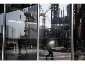 A construction site reflects in the windows of an office tower in the central business district in Beijing, China, on Monday, Oct. 30, 2023. China's stock turnover rose above 1 trillion yuan ($136 billion) Oct. 30 for the first time in about two months, in a sign that trading appetite is returning after policymakers took more steps to boost demand. Bloomberg