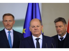 Olaf Scholz, Germany's chancellor, center, flanked by Christian Lindner, Germany's finance minister, left, and Robert Habeck, Germany's economy minister, during a news conference in Berlin, Germany, on Wednesday, Nov. 8, 2023. Scholz's advisers joined a host of other organizations in downgrading their outlook for the German economy, cutting their forecast for this year to a contraction of 0.4% and predicting a significantly weaker-than-expected recovery in 2024. Photographer: Krisztian Bocsi/Bloomberg