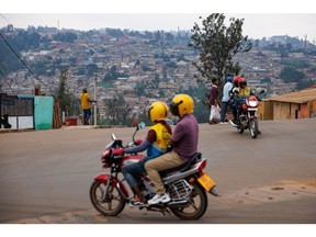 Passengers ride motorbike taxis in Kigali, Rwanda, on Saturday, Nov. 11, 2023. The UK's controversial flagship immigration policy faces its sternest test this week, when the nation's top court will decide whether the government's plan to deport asylum seekers to Rwanda is lawful.