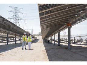 Abdulaziz Alobaidli, chief operating officer of Masdar, right, and Said Negar, site manager at the Dhafra solar park, at the Dhafra solar power plant near Abu Dhabi, United Arab Emirates, on Monday, Nov. 13, 2023. In June, Masdar and Taqa, the Abu Dhabi National Energy Co., began commercial operations at the 2-gigawatt Dhafra solar plant, developed with partners Jinko Power Co. and Electricite de France SA's renewables arm and formally inaugurated it on Thursday.