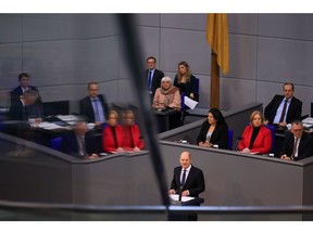 Olaf Scholz, Germany's chancellor, addresses lawmakers, on the Federal Constitutional Court's ruling on the €60 billion ($65.2 billion) climate fund, at the Bundestag in Berlin, Germany, on Tuesday, Nov. 28, 2023. Scholz promised that his government will forge ahead with investments needed to modernize the economy and maintain international competitiveness even after this month's court ruling upended its budget planning.