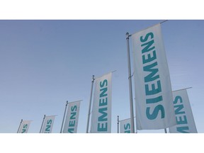 MUNICH, GERMANY - JANUARY 24:  Flags of Siemens global powerhouse in electronics and electrical engineering are seen prior to the annual shareholder meeting at Olympiahalle on January 24, 2008 in Munich, Germany. 'The first quarter of fiscal 2008 meets our expectations: Business volume developped positively.' announced Peter Loescher, summarizing the first quarter of the current fiscal year: 'We booked nine percent more orders compared to the prior-year quarter, and revenue grew 10 percent to 18,4 Billion Euro.'