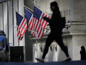 A pedestrian passes the New York Stock Exchange.