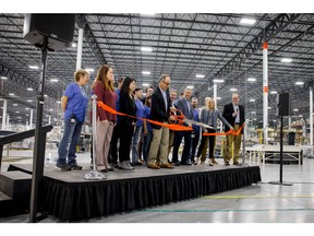 Mark Genender, Chairman of the Board of Directors and Interim CEO at Serta Simmons Bedding, cuts the ribbon for the company's new 500,000 square-foot manufacturing plant in Wisconsin.