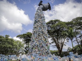 A giant art sculpture shows plastic bottles flowing from a tap