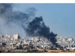 Smoke billows during an Israeli airstrike along the border with Gaza on Nov. 8. Photographer: Ronaldo Schemidt/AFP/Getty Images