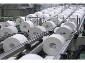 Rolls of toilet paper move along a conveyor. Photographer: Bloomberg Creative Photos/Bloomberg Creative Collection