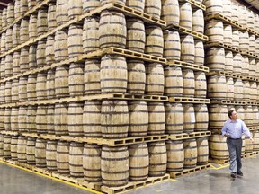 FILE - A Diageo employee walks by barrels of whiskey stored in a new warehouse at the George Dickel distillery near Tullahoma, Tenn. on Aug. 14, 2014. Spirits and beer giant Diageo saw billions wiped off its market value on Friday, Nov. 10, 2023 after it warned that a sharp slowdown in its business in Latin America and the Caribbean was hitting sales and potential profits. In early trading in London, the company's share price was down by 14% after it told investors that it expects growth in the first half of the current financial year to be slower than the previous half-year