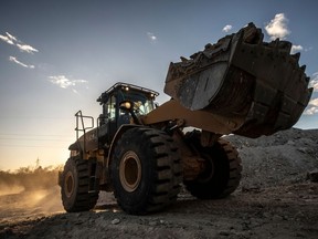 A bulldozer moves lithium ore at a mine in Brazil. Exxon Mobil say it will produce lithium in Arkansas.