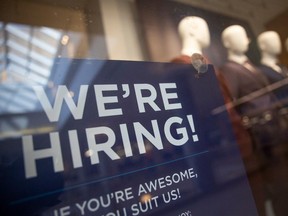 A hiring sign is posted outside a retailer at the Cornwall Centre on Monday, November 13, 2023 in Regina.
