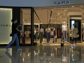 Canada's corporate ethics czar says it's launching a fact-finding investigation into allegations that Zara Canada Inc. is working with companies that use forced labour in China. People tour by a ZARA flagship store at a shopping mall in Beijing, Wednesday, June 21, 2023. THE CANADIAN PRESS/AP-