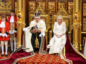 Britain's Queen Camilla sits alongside Britain's King Charles III as he reads the King's speech from The Sovereign's Throne in the House of Lords chamber, during the State Opening of Parliament, at the Houses of Parliament in London.