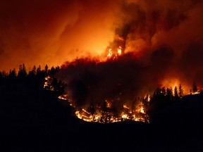 The McDougall Creek wildfire burning in the hills of West Kelowna, B.C., on Aug. 17.