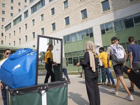 Volunteers help families move their belongings into student housing during the University of Regina's student move-in day.