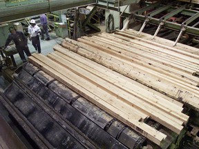 A worker controls a hopper full of cedar lumber at Interfor Corp.'s Hammond Cedar Mill in Maple Ridge, B.C.