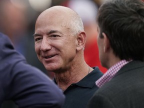 FILE - Amazon founder Jeff Bezos is seen on the sidelines before the start of an NFL football game, Sept. 15, 2022, in Kansas City, Mo. After nearly three decades, Bezos is leaving Seattle. In a Instagram post, the Amazon founder announced plans to return to Miami -- where he spent his high school years -- to be closer to his parents and his partner, Lauren Sánchez.