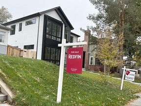 Signs stand in front of homes for sale along South St. Paul Street Thursday, Oct. 26, 2023, in southeast Denver. On Thursday, Freddie Mac reports on this week's average U.S. mortgage rates.