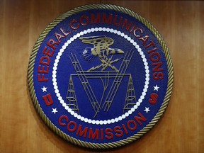 FILE - The seal of the Federal Communications Commission (FCC) is seen before an FCC meeting to vote on net neutrality, Dec. 14, 2017, in Washington. On Wednesday, Nov. 15, 2023, the FCC enacted new rules intended to eliminate discrimination in access to internet services, a move which regulators are calling the first major U.S. digital civil rights policy.