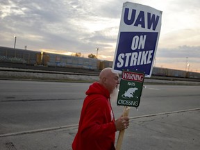 File - Dan Back, a United Auto Workers Local 12 member, pickets during the ongoing UAW strike at the Stellantis Toledo Assembly Complex on Thursday, Oct. 26, 2023, in Toledo, Ohio. Members of the United Auto Workers union moved closer to approving a contract agreement with Stellantis on Friday, Nov. 17, as two large factories in Detroit voted overwhelmingly for the deal.