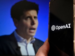 Former OpenAI CEO Sam Altman is seen in this photo illustration beside the OpenAI logo on a smart phone screen. The news on Friday that four members of the company's board had sacked Altman shocked the tech world.