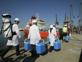 FILE - Technical personnel enter a ship loaded with drinking water docked in the Spanish port of Barcelona, Spain on May 13, 2008 as part of an unprecedented emergency plan to alleviate a drought in Barcelona. Tighter water restrictions for drought-stricken northeast Spain have gone in effect Wednesday Nov. 29, 2023 as authorities in Catalonia say that Barcelona may need to have fresh water shipped in by boat in the coming months. Catalonia is suffering its worst drought on record with reservoirs that provide water for some six million people filled to just 18% of their capacity.