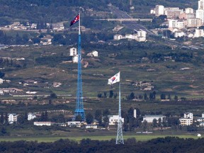 FILE - Flags of North Korea, rear, and South Korea, front, flutter in the wind as pictured from the border area between two Koreas in Paju, South Korea, on Aug. 9, 2021. South Korea said Monday, Nov. 6, 2023, it plans to launch its first domestically built spy satellite at the end of this month as part of its efforts to better monitor rival North Korea and deter its potential aggressions.