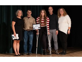 Madeleine Caza, Grade 11 student at St. Patrick High School, Thunder Bay, ON, was presented with the ACT Rescuer Award during the school's awards ceremony on Wednesday, Nov. 1. She received the award for using the knowledge and skills learned through the ACT High School CPR and AED Program to help save her father's life. From left: Erica Lorentz, teacher; Doug Rivard, Distribution Superintendent for the Provincial Lines Team, Hydro One, and ACT Foundation representative; Madeleine Caza, ACT Rescuer Award recipient; and her family.