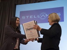 Jacqueline Olivia, head of human resources with Stellantis, shakes hands with Unifor national president Lana Payne during the auto talks in Toronto on Thursday, Aug. 10, 2023.