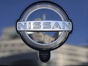 FILE - A Nissan logo is seen on a car at its showroom in Tokyo on Feb. 21, 2023. Nissan's profit zoomed up more than 10-fold in July-September from a year earlier, boosted by a weak Japanese yen and strong vehicle sales around the world.