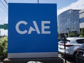 The CAE logo is seen in front of the aerospace company's plant, Thursday, July 21, 2022 in Montreal.