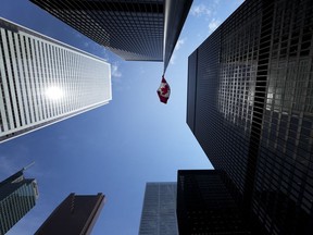 The Bay Street Financial District is shown with the Canadian flag in Toronto on Friday, August 5, 2022. Financial results from some of the biggest names in corporate Canada are expected to come at a fast and furious pace this week.