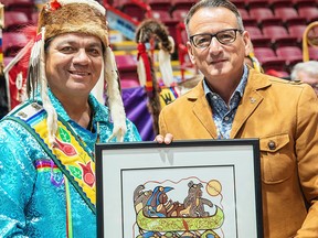 Duke Peltier, trustee of the Robinson Huron Treaty Litigation Trust, left attends a treaty gathering ceremony in Sault Ste. Marie in September with Greg Rickford, Ontario Minister of Indigenous Affairs,right.
