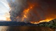 The McDougall Creek wildfire burns in the hills West Kelowna, B.C., on Aug. 17, 2023, as seen from Kelowna.