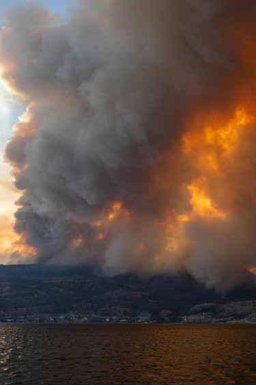 The McDougall Creek wildfire burns in the hills West Kelowna, B.C., on Aug. 17, 2023, as seen from Kelowna.