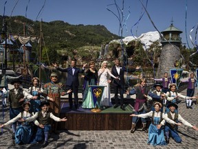 Paul Chan, Hong Kong's financial secretary, left, and Josh D'Amaro, chairperson of Disney Experiences, right, pose with performers in front of the press during the opening ceremony of the World of Frozen themed area at Disneyland Resort in Hong Kong, Monday, Nov. 20, 2023.