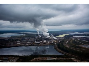 Steam rises from the Syncrude Canada Ltd. upgrader plant in this aerial photograph taken above the Athabasca oil sands near Fort McMurray, Alberta, Canada, on Monday, Sept. 10, 2018. While the upfront spending on a mine tends to be costlier than developing more common oil-sands wells, their decades-long lifespans can make them lucrative in the future for companies willing to wait.