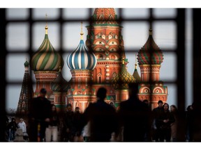 Pedestrians walk by Saint Basil's Cathedral on Red Square in Moscow, Russia, on Sunday, May 2, 2021. Facing a rising wave of Covid-19 infections and a vaccination rate that isn't keeping up, the Kremlin is trying to contain the epidemic without alarming Russians.