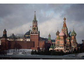 The Spasskaya tower of the Kremlin, center, and Saint Basil's Cathedral, right, in Moscow, Russia, on Tuesday, Feb. 22, 2022. The ruble tumbled the most since March 2020 after President Vladimir Putin recognized self-declared separatist republics in east Ukraine, deepening a standoff with the West. Photographer: Andrey Rudakov/Bloomberg